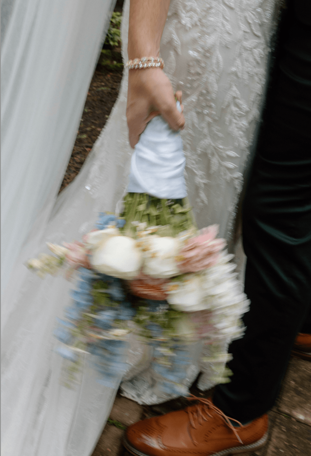 Bride holding her bouquet at her side
